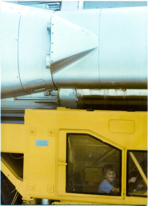 Kai MacLaren sits, enjoying himself hugely, hands on the steering wheel, in the “RIGHT TILLERMAN ENCLOSURE” of the “Guided Missile Semitrailer” which is used to transport the Atlas ICBM, a small part of which can be seen above him, at the Air Force Space and Missile Museum, Cape Canaveral, Florida. Click the links in the text box at left for more information on the Atlas missile and its transport semitrailer. Photograph by James MacLaren. Kai MacLaren sits, enjoying himself hugely, hands on the steering wheel, in the “RIGHT TILLERMAN ENCLOSURE” of the “Guided Missile Semitrailer” which is used to transport the Atlas ICBM, a small part of which can be seen above him, at the Air Force Space and Missile Museum, Cape Canaveral, Florida. Click the links in the text box at left for more information on the Atlas missile and its transport semitrailer. Photograph by James MacLaren.